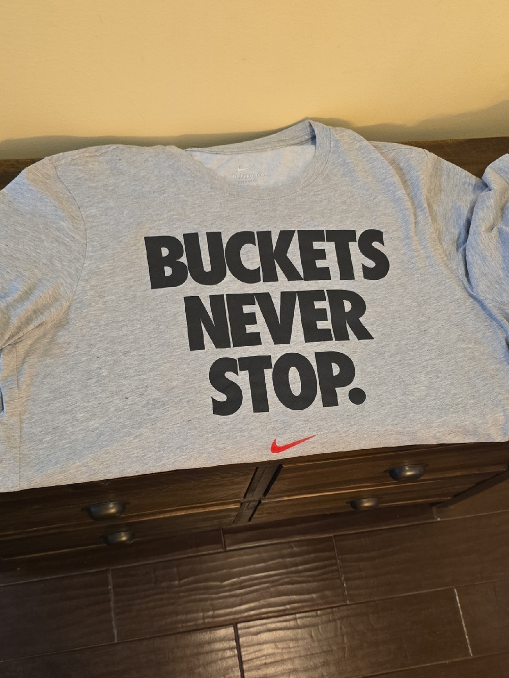 Mens Nike Light Gray Graphic Tee with Black Text and Red Swoosh